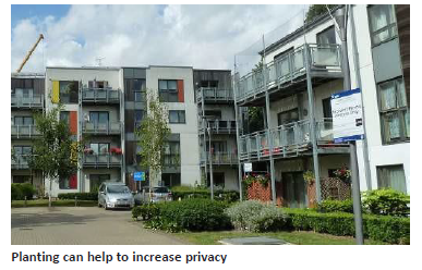 Image of apartment buildings with greenery, planting can help increase privacy. 