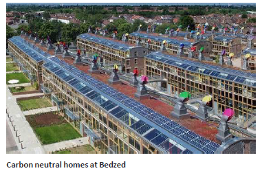Aerial view of carbon-neutral homes with roofs made of solar panel systems, carbon neutral homes at Bedzed