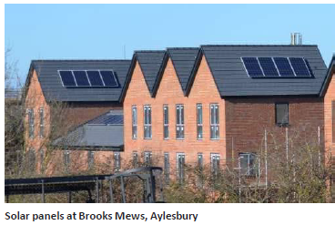 A row of houses with solar panels on gable rooftops. Solar panels at Brooks Mews, Aylesbury.