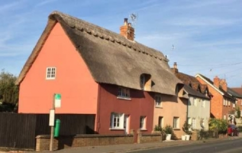 Image of Varied roof pitches and materials, including thatch, tiles and harmonious coloured lime washed render