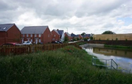 Attenuation pond is poorly integrated into the residential development so that it has limited visual amenity value
