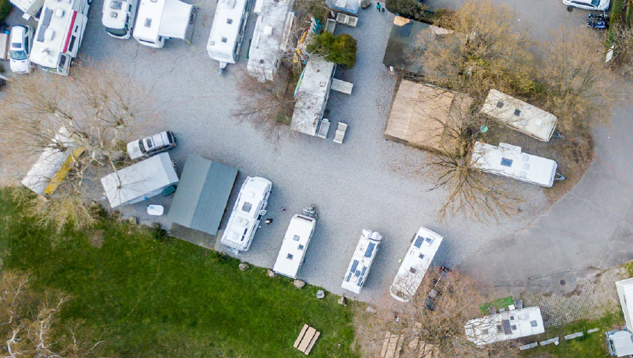 Panoramic view of a travelling community, showing caravans across the plot.