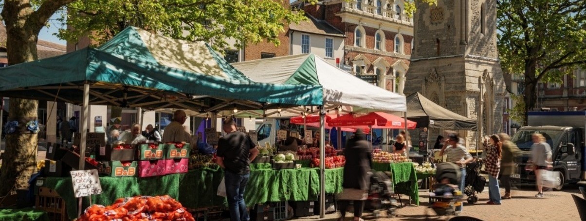 Market Square in Aylesbury Town with market stalls and visitors